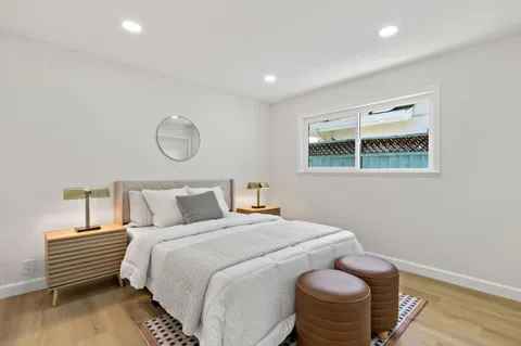 a bedroom with a bed and a chair