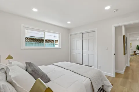 a bedroom with a bed and a painting on the wall