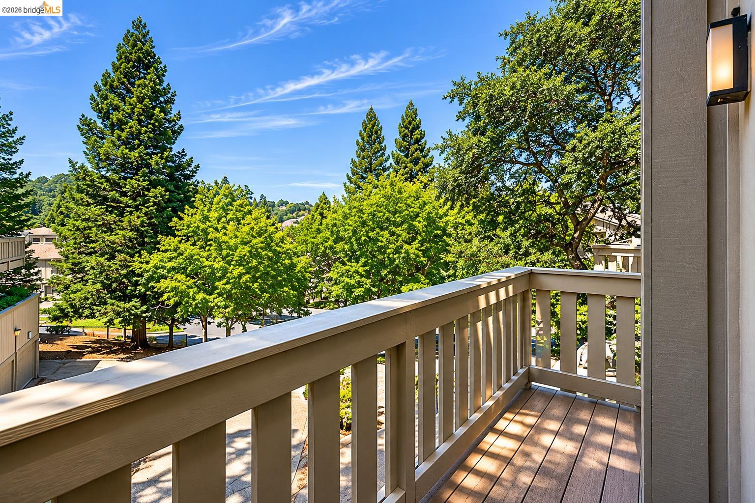261 Redhawk Road Novato, CA 94949 - Photo 37 of 44 Private balcony featuring composite decking, a sturdy railing system, and an exterior wall-mounted light fixture