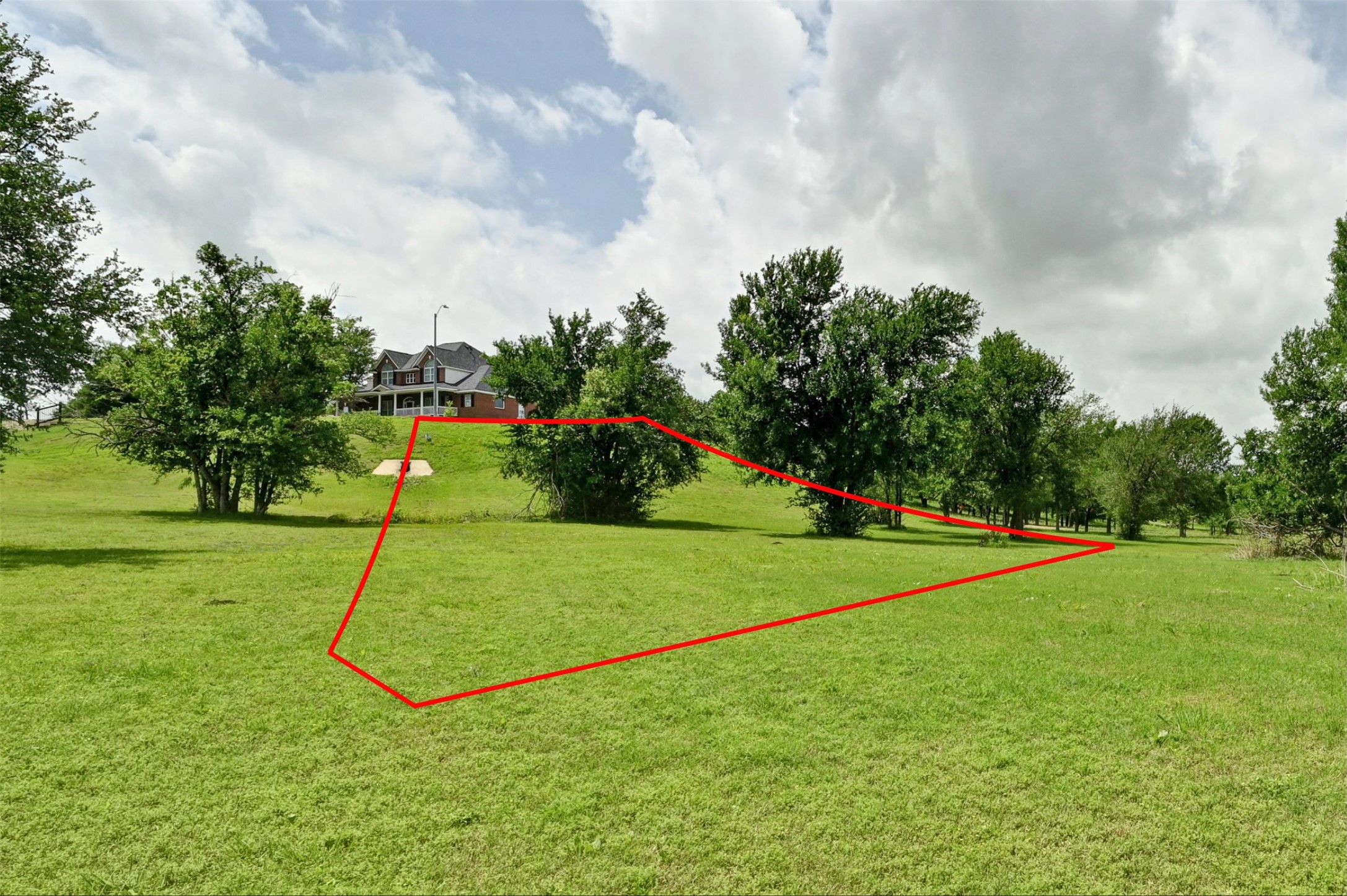 1700 Tanner Loop Taylor, TX 76574 - Photo 9 of 32 Expansive grassy lot with scattered mature trees and gentle slopes
