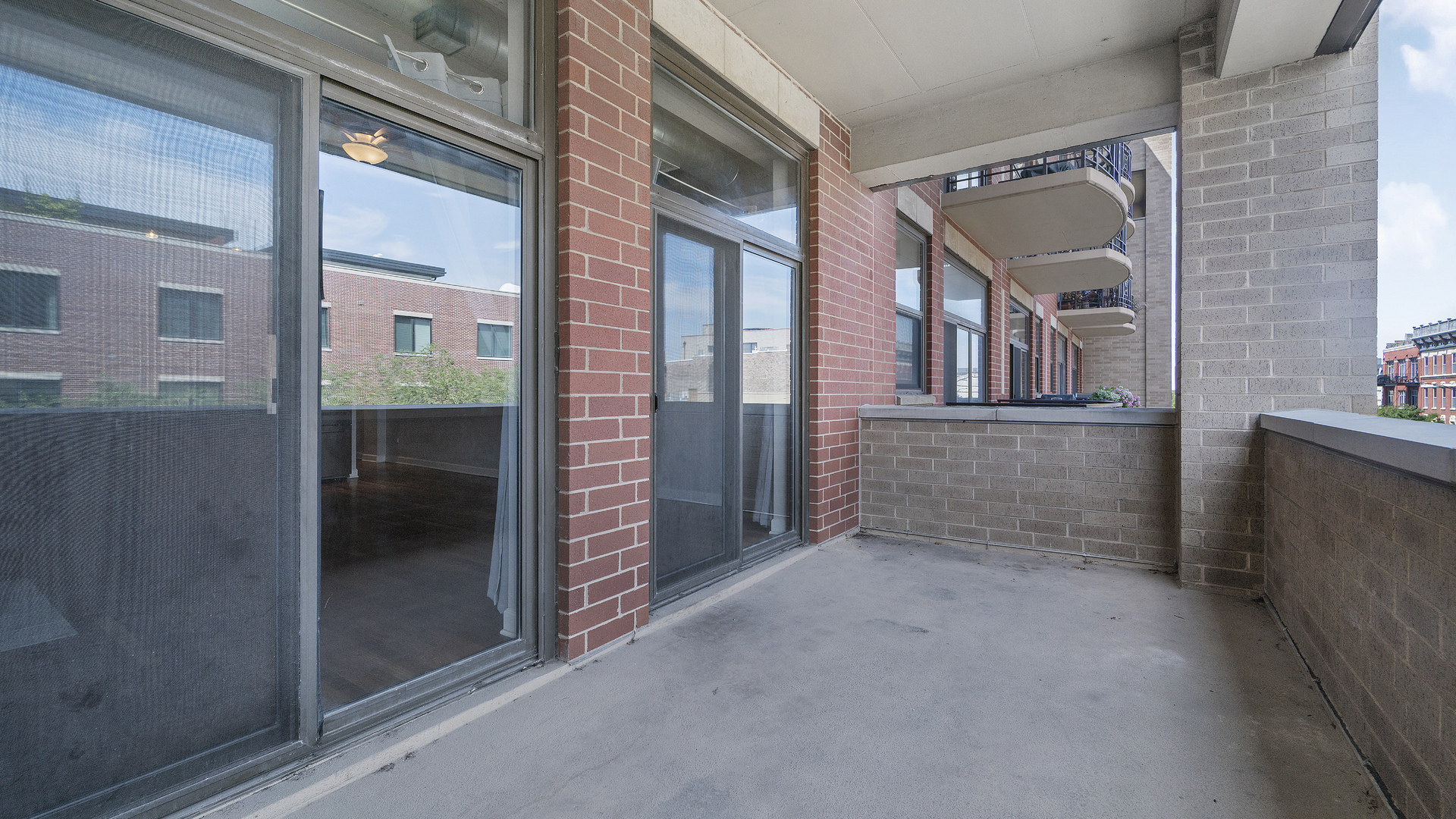 1301 West Madison Street, Unit 304 Chicago, IL 60607 - Photo 15 of 15 a view of a brick house with an outdoor space