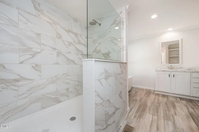 a kitchen with white cabinets appliances and wooden floor
