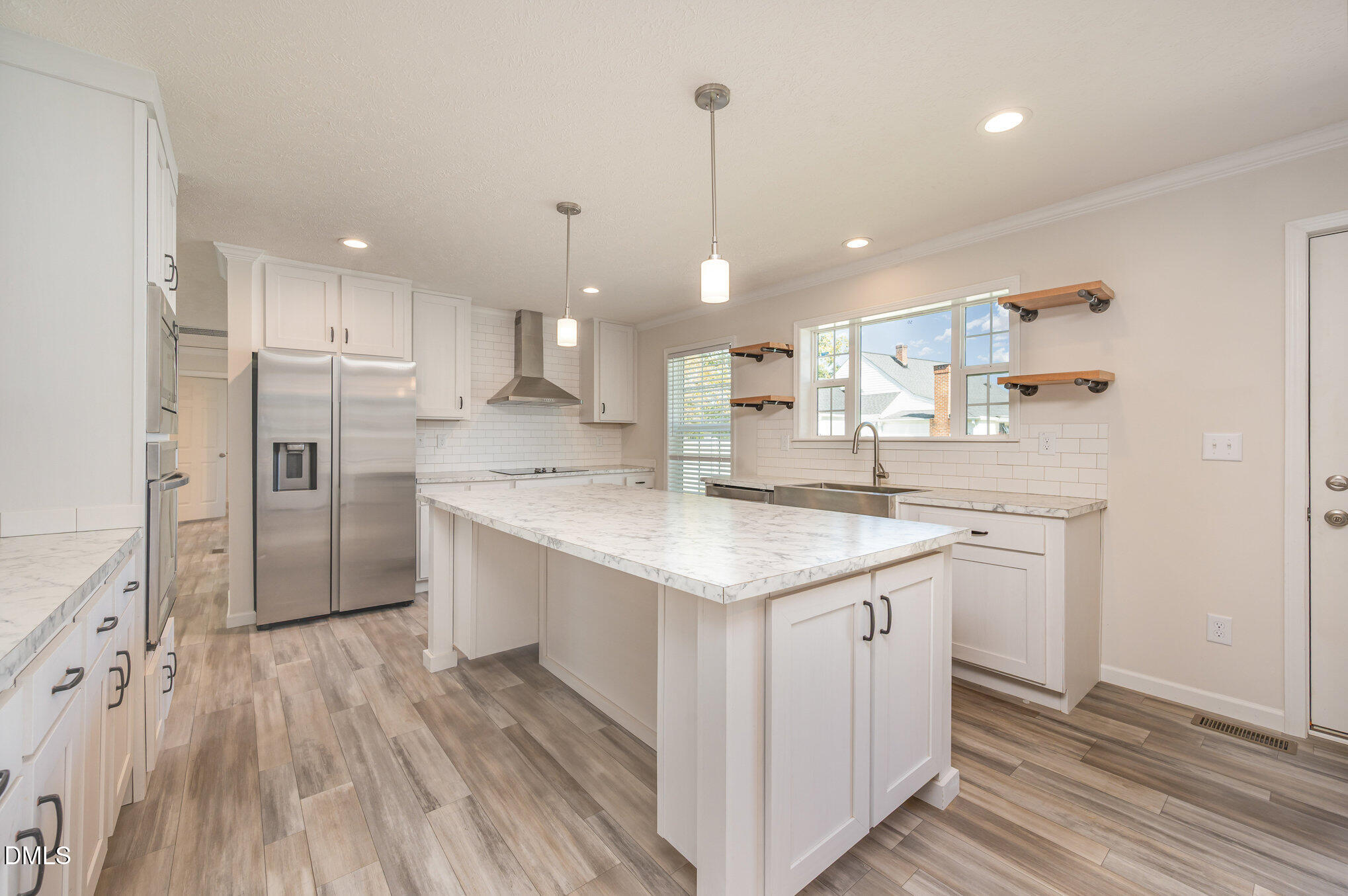 2551 Old Durham Road Roxboro, NC 27573 - Photo 12 of 28 a kitchen with white cabinets appliances and wooden floor