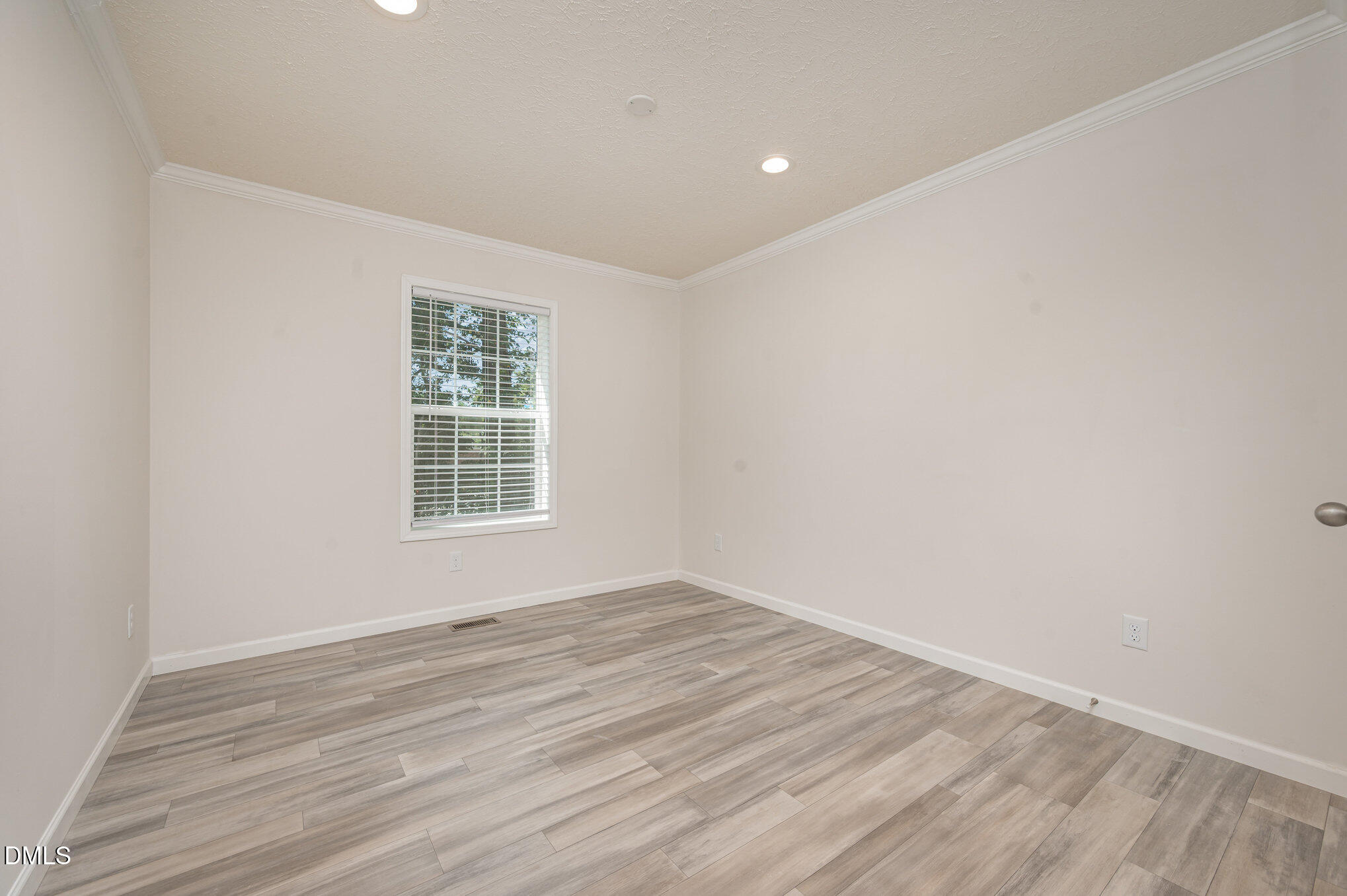 2551 Old Durham Road Roxboro, NC 27573 - Photo 17 of 28 an empty room with wooden floor and windows