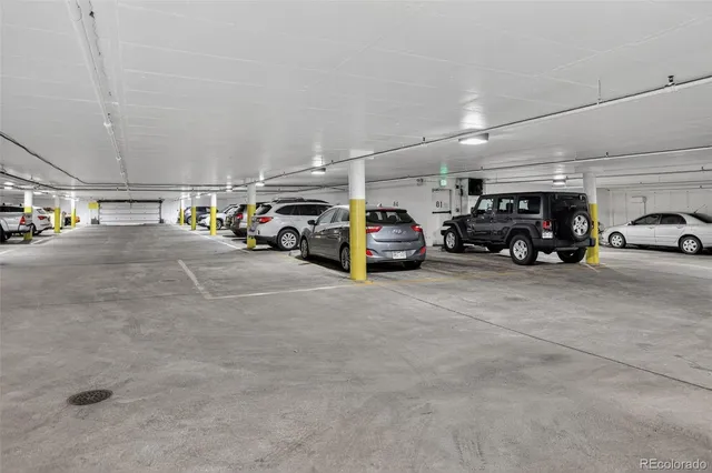 a view of parking garage with cars