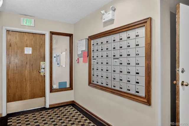 a view of a hallway with wooden floor and closet