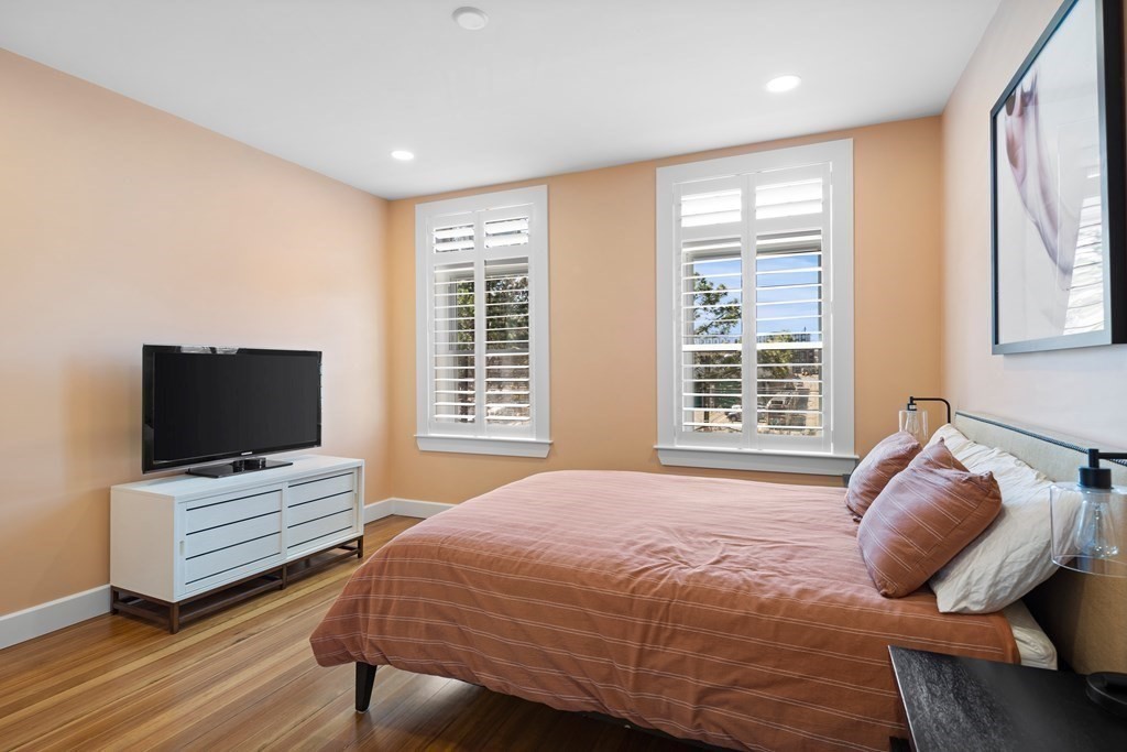 23 Strathmore Road, Unit 3 Brookline, MA 02445 - Photo 14 of 26 a bedroom with a bed and flat screen tv