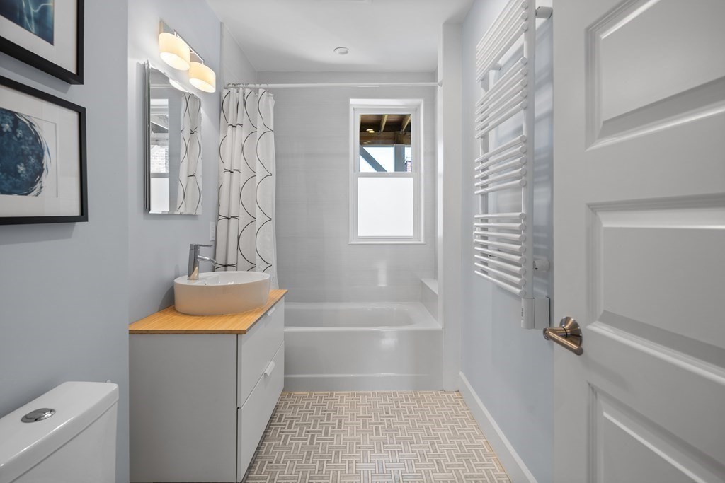 23 Strathmore Road, Unit 3 Brookline, MA 02445 - Photo 19 of 26 a bathroom with a tub sink and toilet