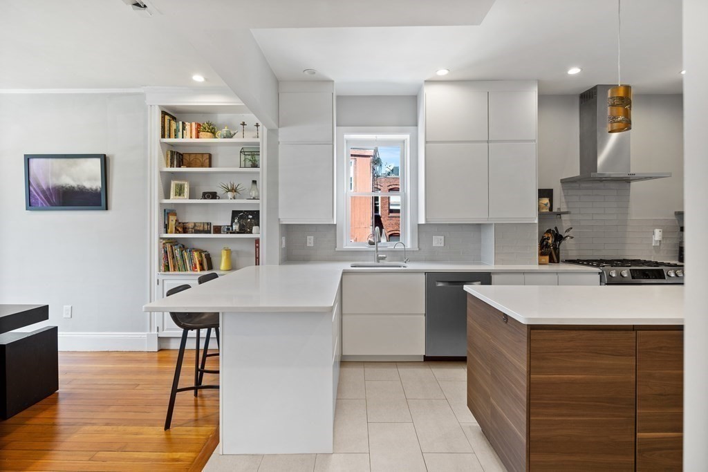 23 Strathmore Road, Unit 3 Brookline, MA 02445 - Photo 2 of 26 a kitchen with a sink cabinets and wooden floor