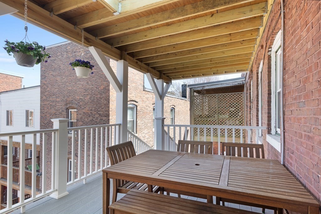 23 Strathmore Road, Unit 3 Brookline, MA 02445 - Photo 22 of 26 a view of a wooden chairs on the roof deck
