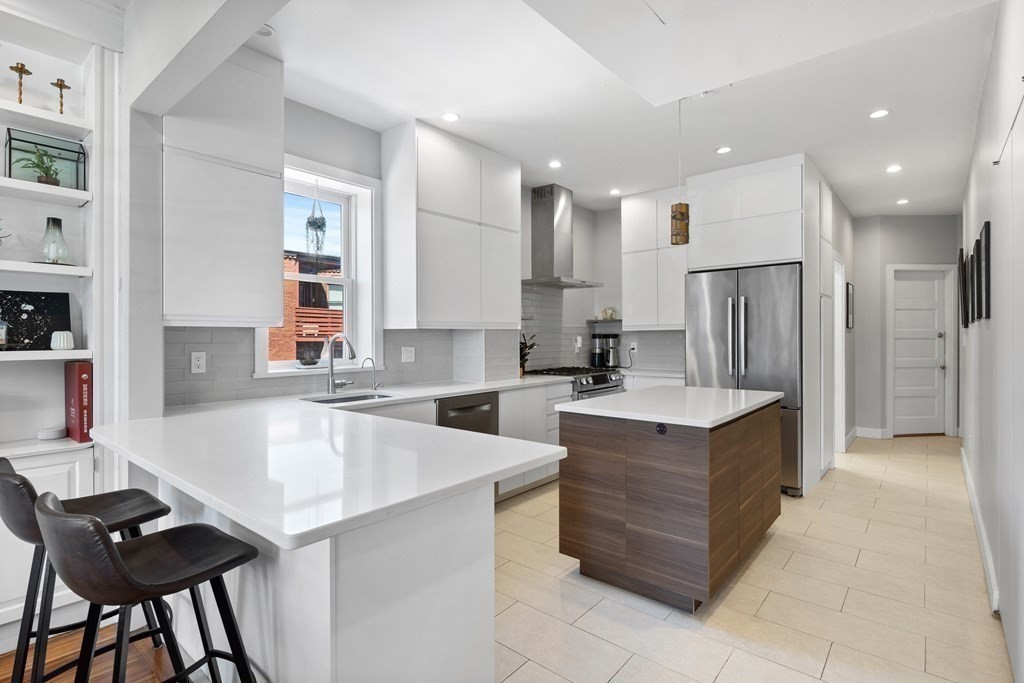 23 Strathmore Road, Unit 3 Brookline, MA 02445 - Photo 3 of 26 a large kitchen with a large counter top appliances and cabinets