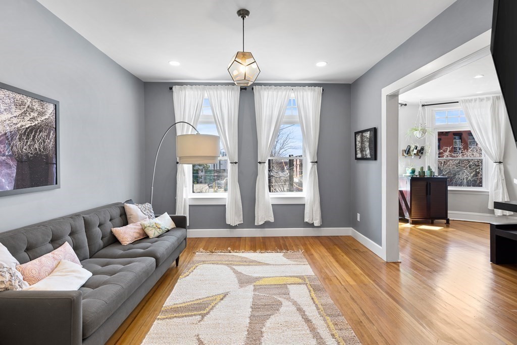 23 Strathmore Road, Unit 3 Brookline, MA 02445 - Photo 6 of 26 a living room with furniture and a chandelier