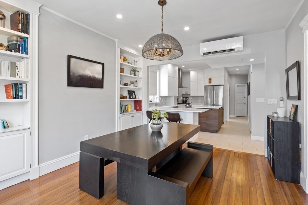23 Strathmore Road, Unit 3 Brookline, MA 02445 - Photo 8 of 26 a kitchen with a dining table chairs stainless steel appliances and cabinets