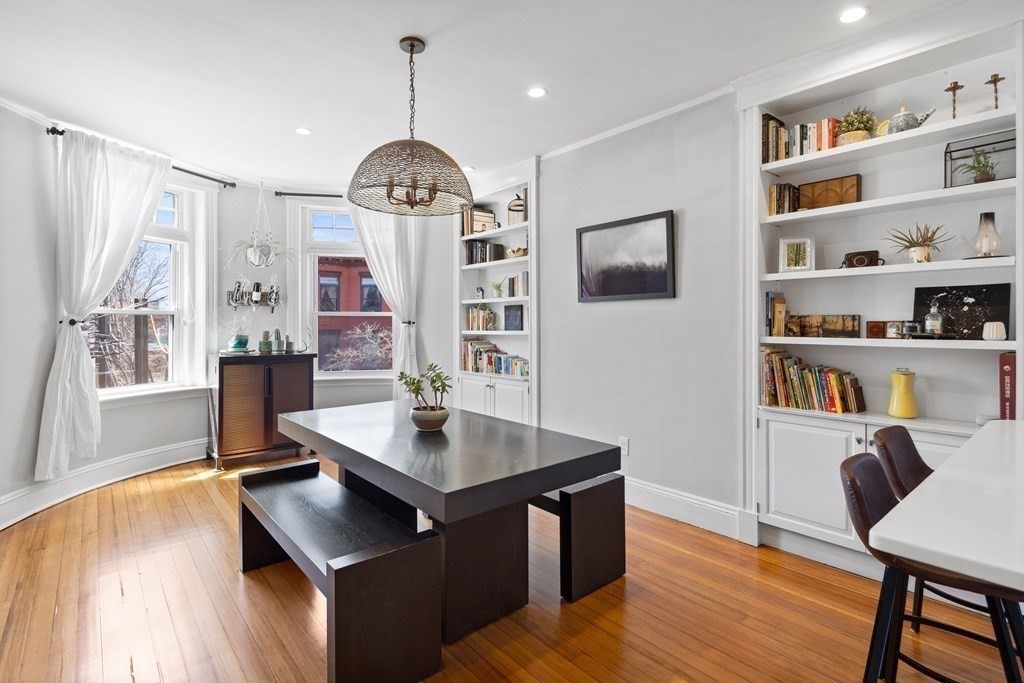 23 Strathmore Road, Unit 3 Brookline, MA 02445 - Photo 9 of 26 a view of a workspace with furniture and a bookshelf