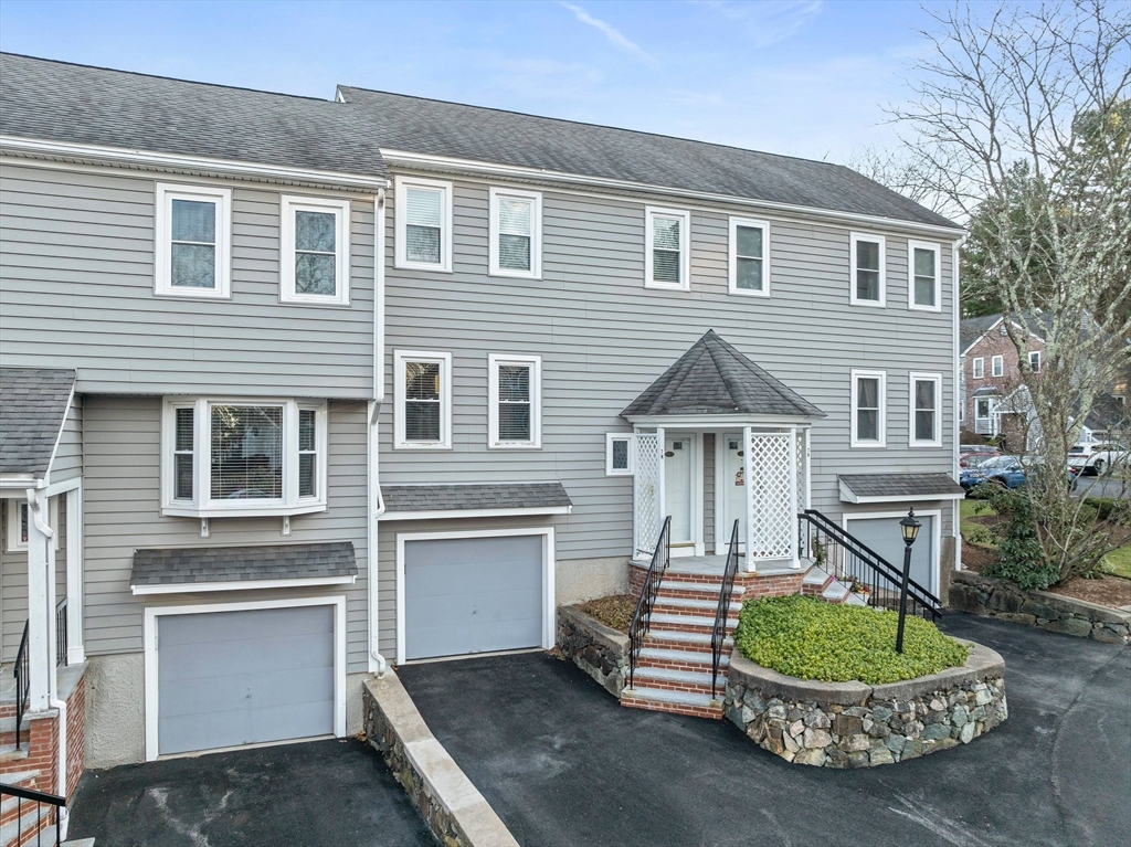 84 Walpole Street, Unit 7M Canton, MA 02021 - Photo 24 of 31 a front view of a house with a yard and potted plants