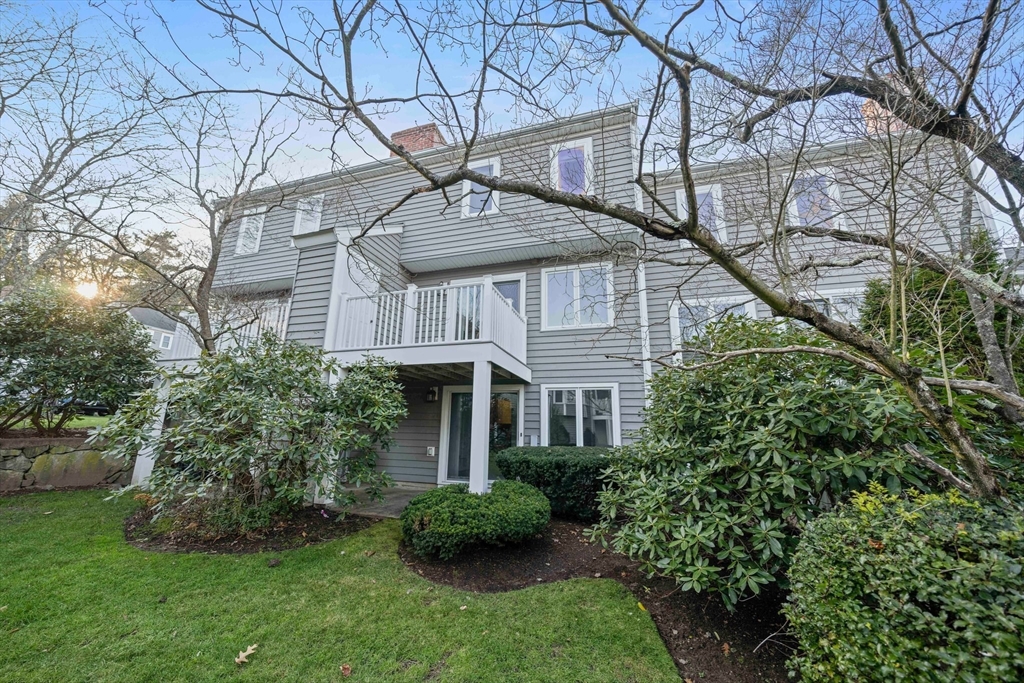84 Walpole Street, Unit 7M Canton, MA 02021 - Photo 26 of 31 a view of a house with a yard and potted plants