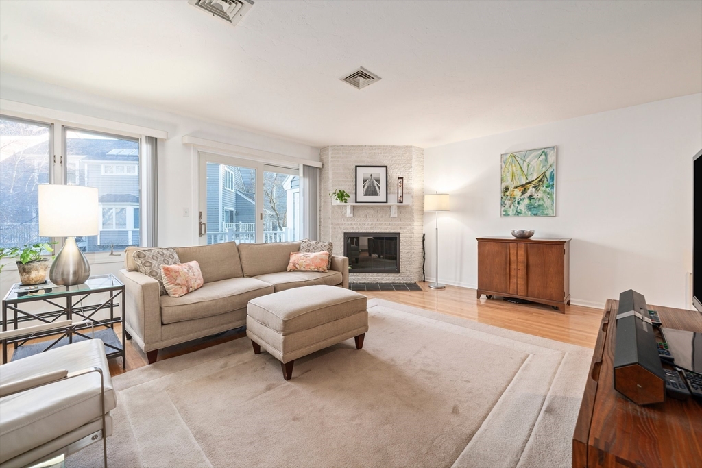 84 Walpole Street, Unit 7M Canton, MA 02021 - Photo 3 of 31 a living room with furniture and a fireplace