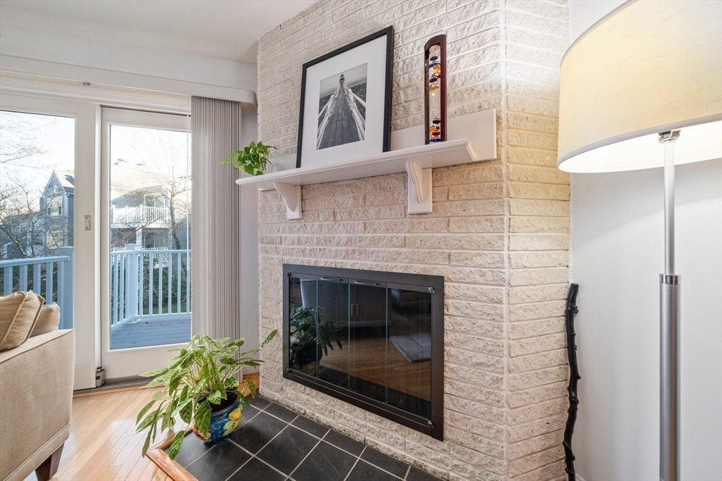 84 Walpole Street, Unit 7M Canton, MA 02021 - Photo 5 of 31 a living room with furniture and a fireplace