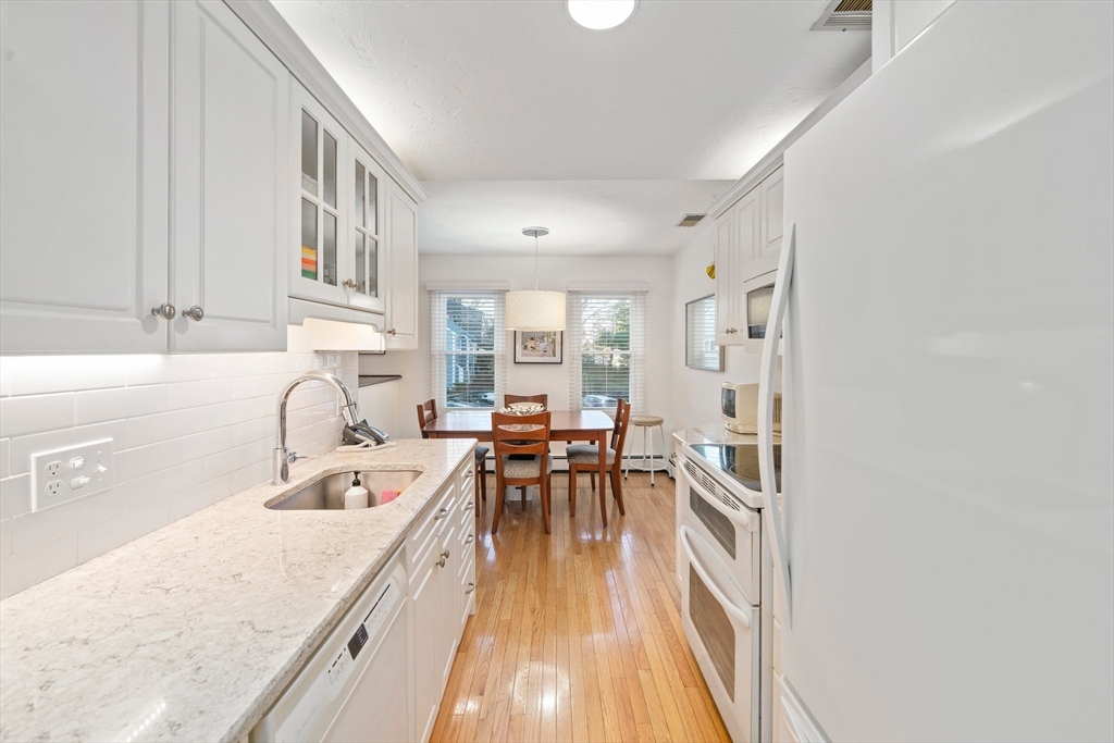 84 Walpole Street, Unit 7M Canton, MA 02021 - Photo 7 of 31 a kitchen with a sink a counter top space and stainless steel appliances