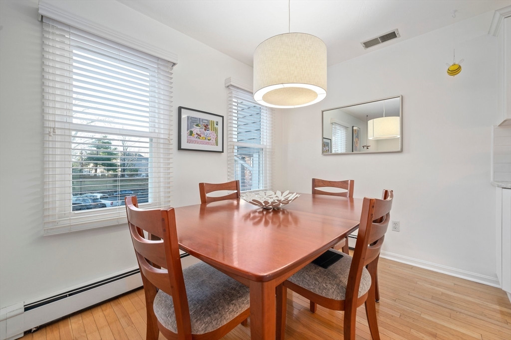 84 Walpole Street, Unit 7M Canton, MA 02021 - Photo 9 of 31 a view of a dining room with furniture and wooden floor