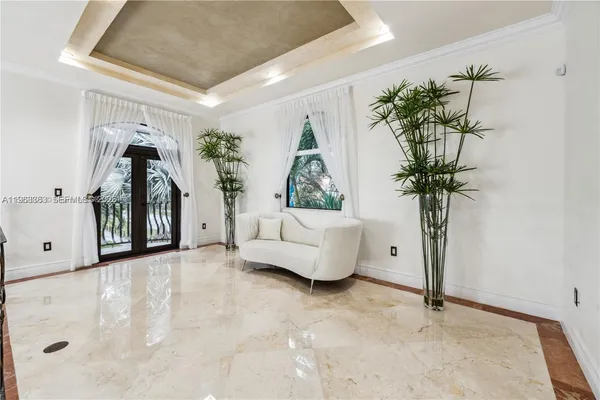 a view of a dining room with furniture and a chandelier
