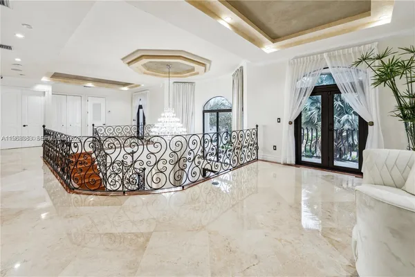 a living room with furniture a rug and a large window