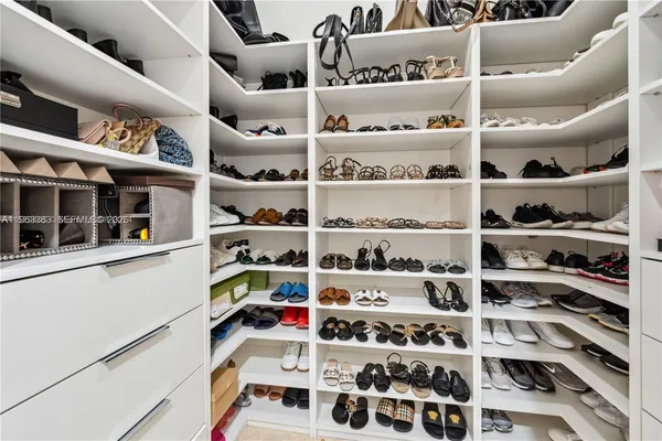 a living room with patio furniture and a floor to ceiling window