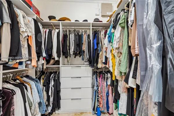 a kitchen with stainless steel appliances kitchen island granite countertop a stove top oven a sink a dining table and chairs with the view of kitchen