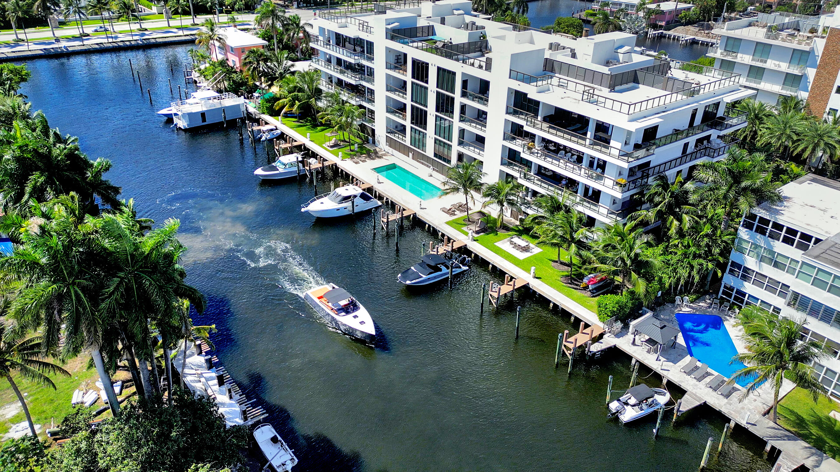 an aerial view of a house with a garden and lake view