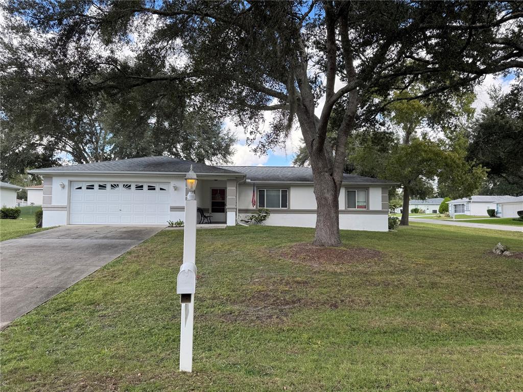 6071 Southwest 105th Place Ocala, FL 34476 - Photo 1 of 13 a view of a house with a yard