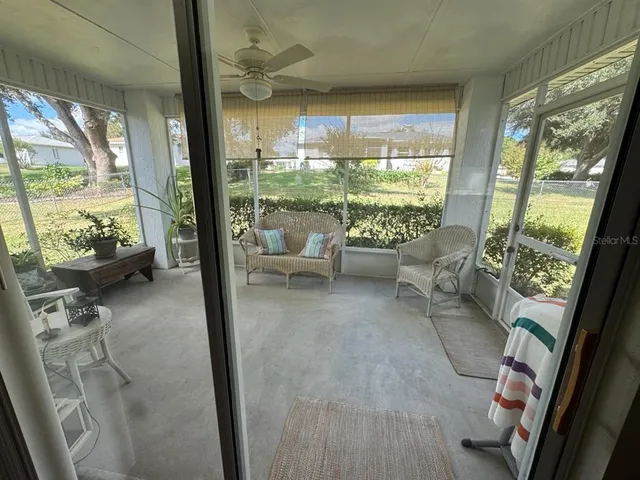 a living room with furniture and a floor to ceiling window