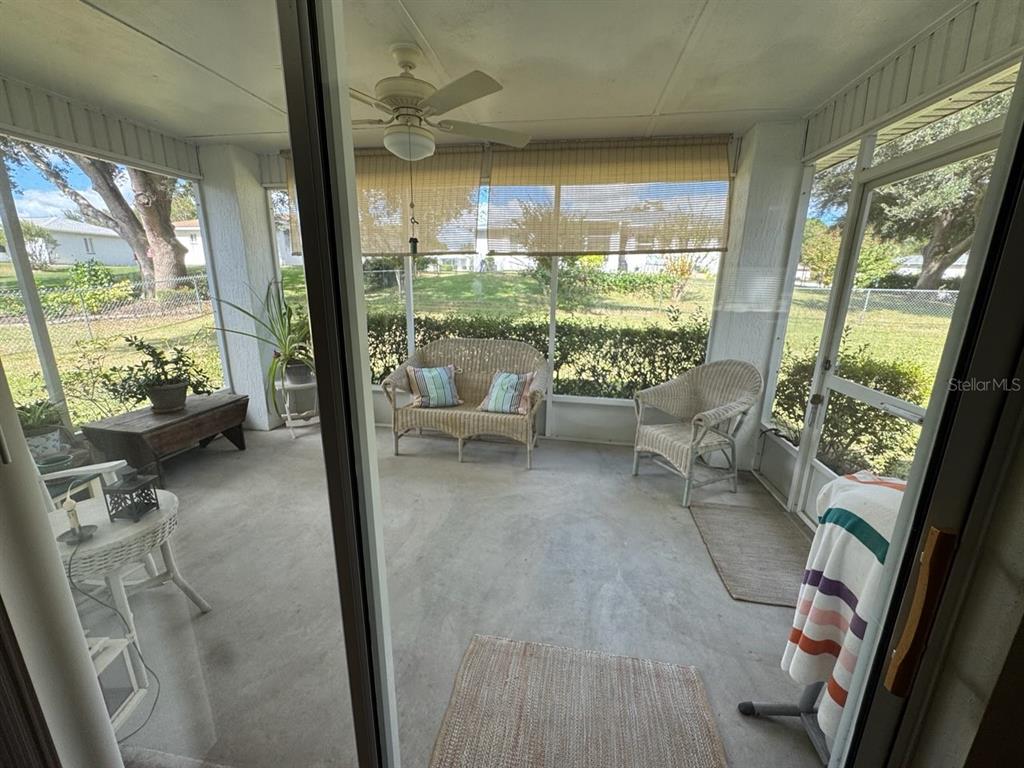 6071 Southwest 105th Place Ocala, FL 34476 - Photo 11 of 13 a living room with furniture and a floor to ceiling window