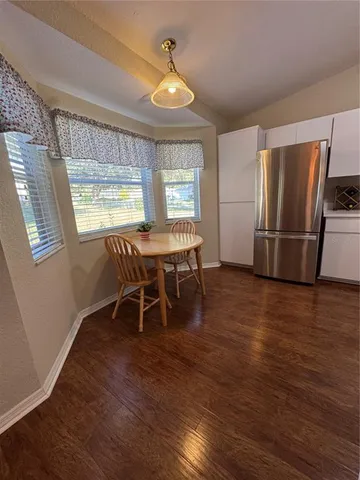 a dining room with furniture and window