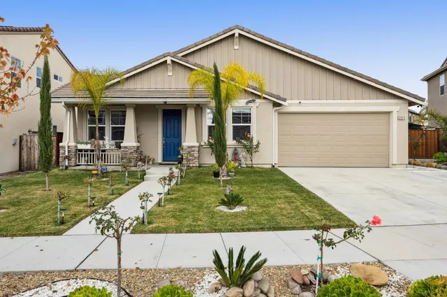 a front view of house with a garden and patio