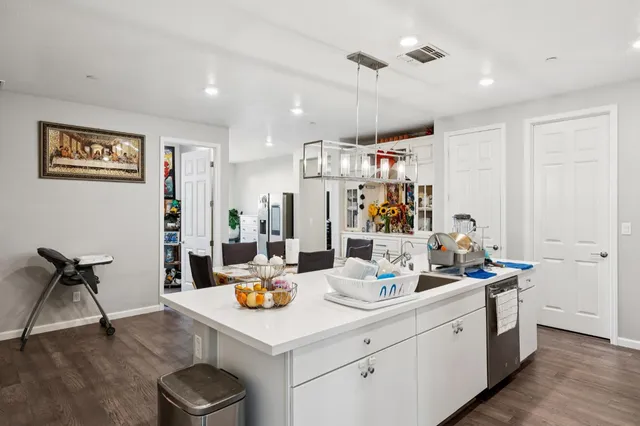 a living room with furniture and kitchen view