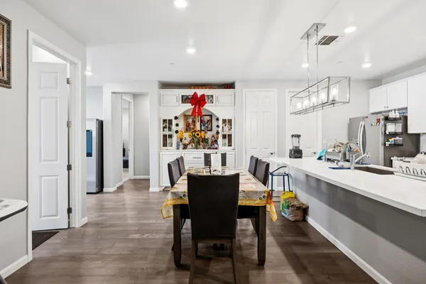 a table with a book shelf and a shelf with wooden floor