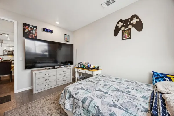 a bedroom with a bed and a flat screen tv