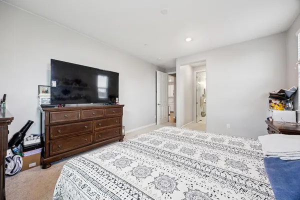 a bathroom with a tub sink and mirror