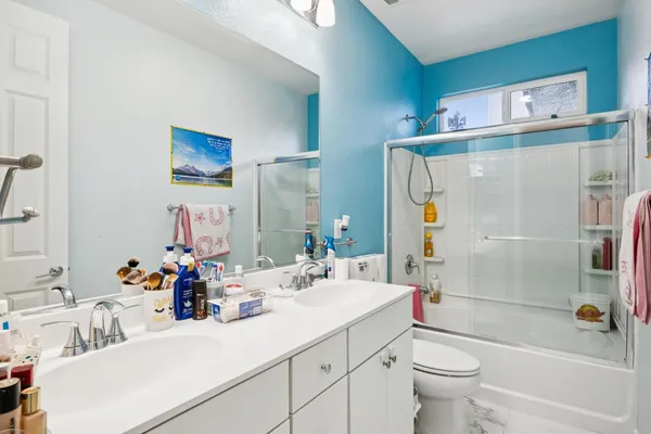 a bedroom with a bed table and a window