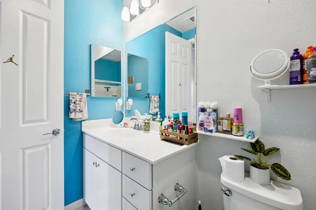 a view of the patio with dining table and chairs under an umbrella