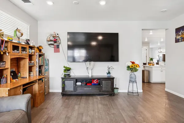 a kitchen with a sink cabinets and wooden floor