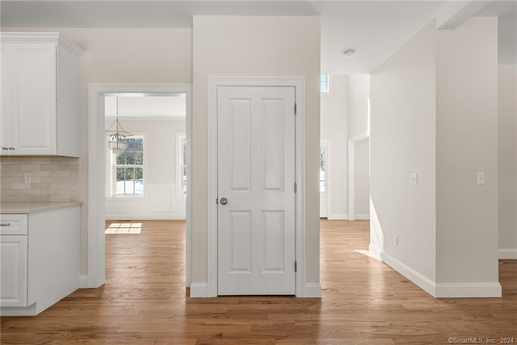 116 Holcomb Hill Road New Hartford, CT 06057 - Photo 11 of 30 Kitchen looking in to the dining room and entrance foyer. Standard trim package and flooring are depicted in this photo.