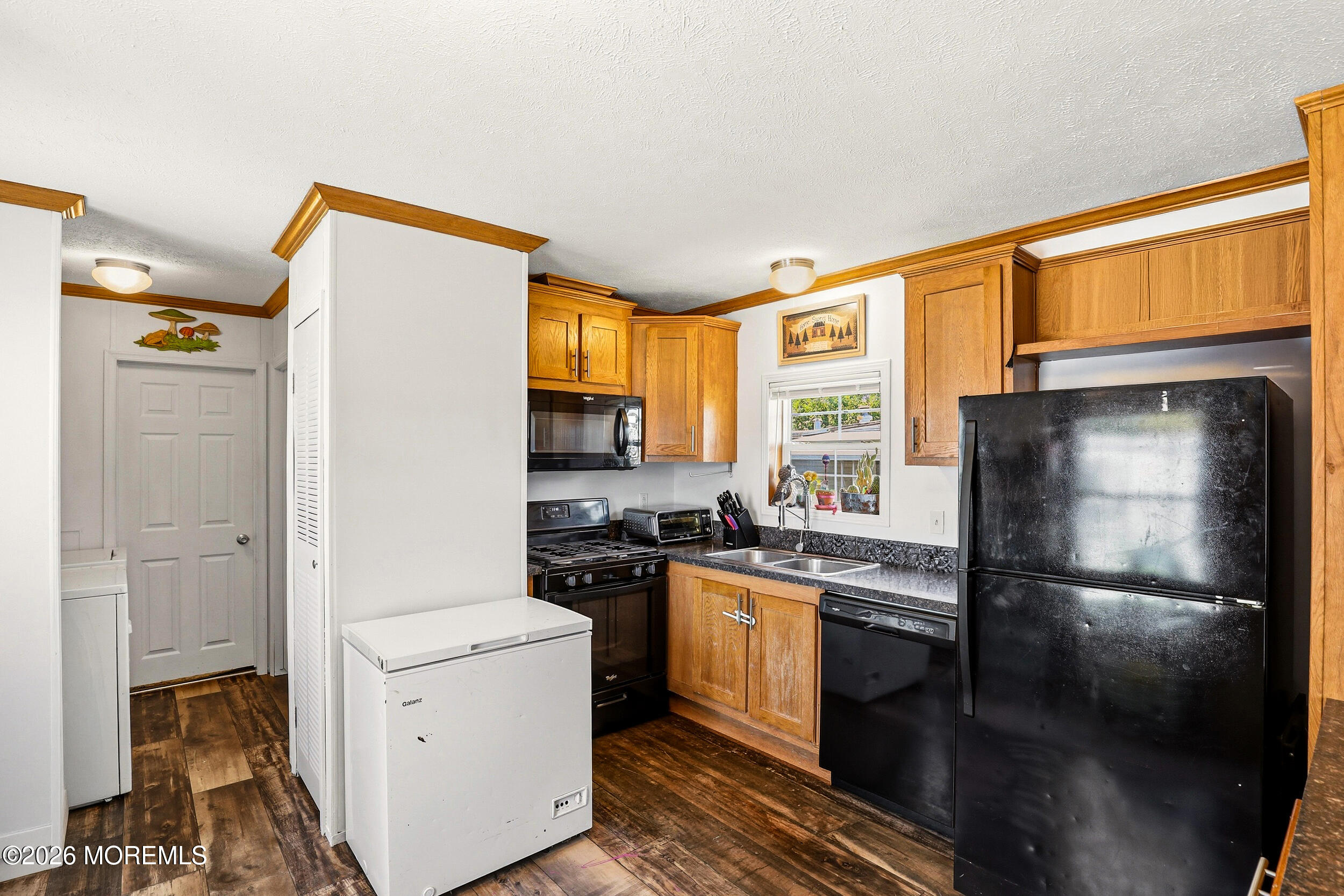 40 Locust Grove Hazlet, NJ 07730 - Photo 7 of 15 a kitchen with a refrigerator a stove top oven a sink and dishwasher with wooden floor
