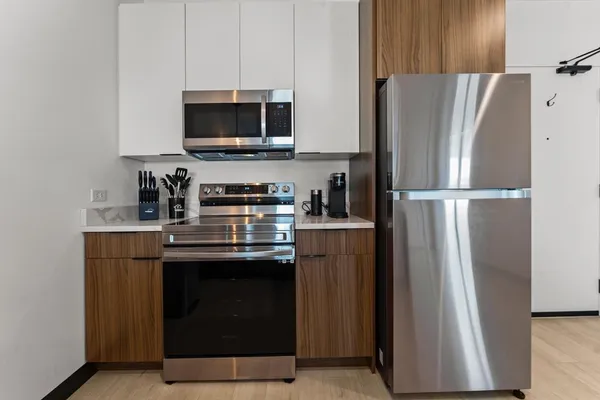 a kitchen with stainless steel appliances a refrigerator stove and microwave