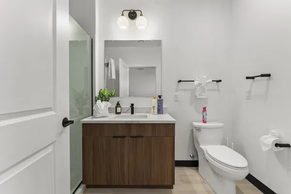 a bathroom with a toilet sink and mirror