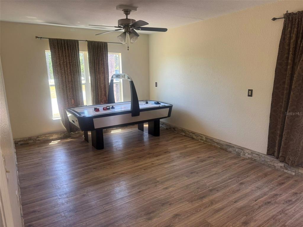 14373 Irving Street Spring Hill, FL 34609 - Photo 4 of 4 a view of room with wooden floor and fan