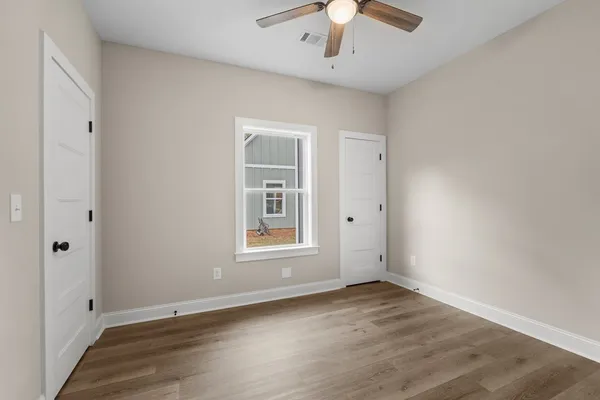 wooden floor in an empty room with a window