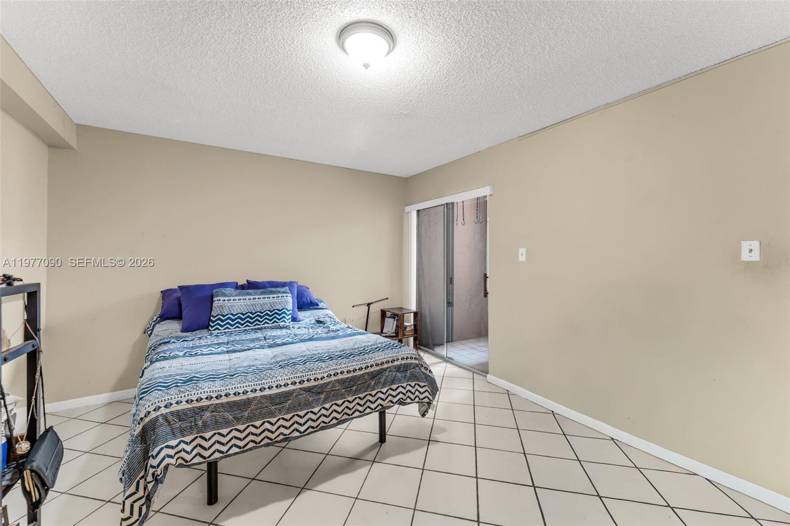 10641 Southwest 108th Avenue, Unit 3D Miami, FL 33176 - Photo 13 of 26 a bedroom with a bed and a mirror