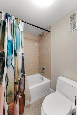 a bathroom with a toilet and a bathtub