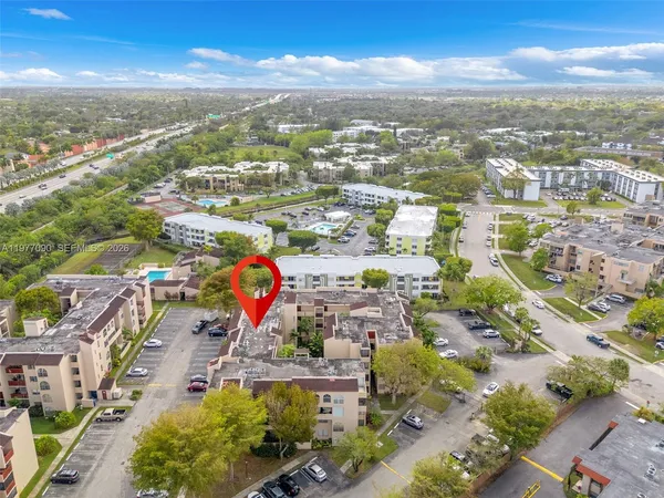 an aerial view of residential building with green space